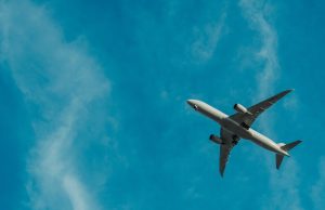 Cathay Pacific Fined $970,000 Over 9.4M Passenger Data Breach Cathay Pacific check-in counters at Hong Kong airport with passenger documents on desks and airline logo visible.