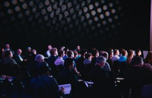 AI Seoul Summit 2024 Produces First Bilateral Declaration World leaders and delegates gather at a conference table for the AI Seoul Summit 2024, with digital screens displaying AI governance principles.