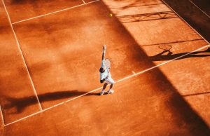 Alcaraz Becomes Youngest to Win Majors on Three Surfaces Carlos Alcaraz celebrates with the French Open trophy on the clay court at Stade Roland Garros after winning the 2024 final.