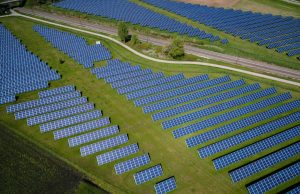 China Solar Capacity Hits 1 Terawatt Global First A vast field of solar panels stretches to the horizon under a bright sky, symbolizing China's record-breaking one terawatt solar capacity.