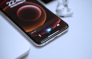 Apple Unveils Free Apple Intelligence Suite at WWDC 2024 Tim Cook presents Apple Intelligence slides on the WWDC 2024 keynote stage as developers record on iPhones.