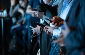 Threads Becomes Fastest-Growing App in History A smartphone displays the Threads app logo on its screen, with Instagram and Meta branding visible in the background.
