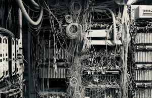 Bengio-Led AI Safety Report Drops January 29 Yoshua Bengio stands at a podium unveiling the International AI Safety Report cover to a room of policymakers.