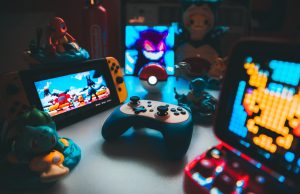 Lenovo Legion Go Ships with Windows 11 A person holding a Lenovo Legion Go handheld gaming device, displaying a game launcher interface on its screen.