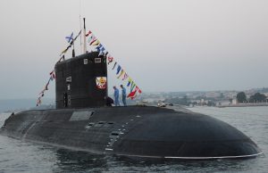South African Navy Loses 3 Submariners to Cape Waves Rough sea off Kommetjie lighthouse with rescue boats searching amid towering waves