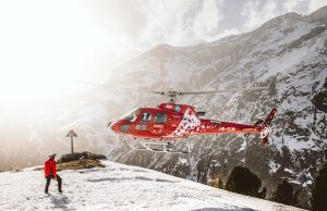 Skier Dies on Mount Washington, Two Injured A skier descends a steep, icy slope on Mount Washington under cloudy skies, with rocky terrain visible in the background.