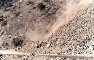 Landslides Strand 1,000 Tourists in Sikkim, Kill 6 Indian Army trucks navigate a muddy, half-collapsed mountain road while clouds cling to steep green slopes after monsoon landslides.
