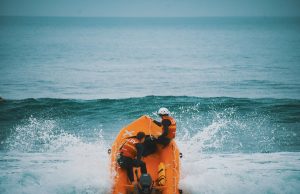 Migrant Boat Capsizes Off Lampedusa, 26 Dead Rescuers pull a body from the Mediterranean Sea near Lampedusa's rocky coast after a migrant boat capsized.