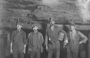 Colombia Rescues 23 Gold Miners Trapped 48 Hours Underground Rescue workers guide dust-covered miners emerging from a narrow tunnel entrance into daylight after two days underground.
