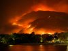 Kemp Weighs Special Session After Georgia Wildfires Smoke rises from a wildfire in southeast Georgia, with burned trees and charred ground visible in the foreground.