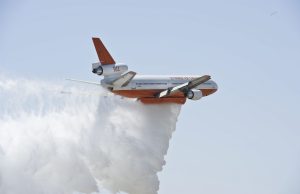 Pilot Dies in Montana Firefighting Plane Crash A firefighting plane drops water over a blazing Montana wildfire near a lake
