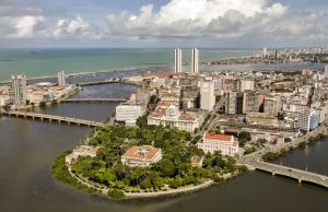 Recife Apartment Collapse Kills 14, 6 Missing Rescuers search through rubble of a collapsed apartment building in Recife, Brazil, amid dust and debris.