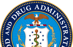 FDA Approves Gilead Yeztugo HIV Drug After Trials Halt Spread FDA officials and Gilead executives shake hands behind a backdrop displaying the Yeztugo logo at the drug approval announcement.