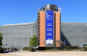 EU Commission Halts Paid Ads on X Over Disinformation European Commission headquarters in Brussels, with a digital display showing the X logo crossed out