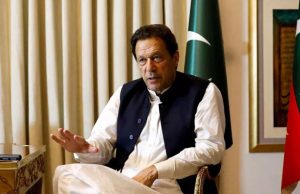 Imran Khan Remains Key Figure in Pakistan Politics Imran Khan addressing a crowd at a political rally in Pakistan, gesturing with his hand while supporters wave flags.