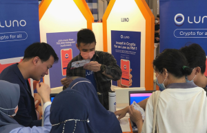 Luno Hits RM4.2 Billion in Crypto Transactions Luno cryptocurrency exchange logo displayed on a smartphone screen with Bitcoin and Ethereum symbols in the background.