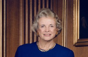 Sandra Day O’Connor, First Woman on Supreme Court, Dies at 93 Sandra Day O'Connor in her judicial robe, standing before the U.S. Supreme Court building with a determined expression.