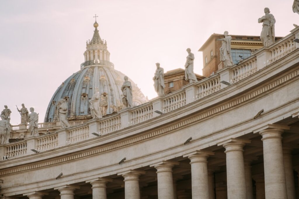 Cardinal electors in red robes gather inside the Sistine Chapel for the papal conclave.
