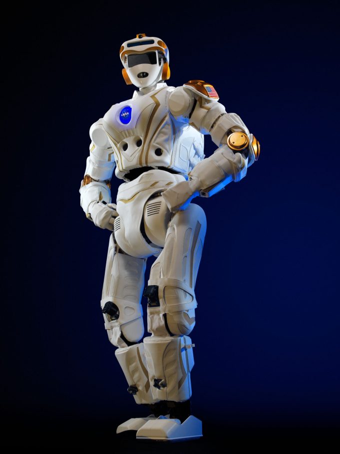 A humanoid robot running on a Beijing race course, crossing a finish line with spectators watching.