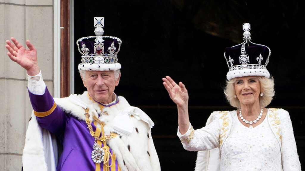 Charles III and Camilla sit enthroned in Westminster Abbey during their coronation ceremony, surrounded by clergy and royal family members.